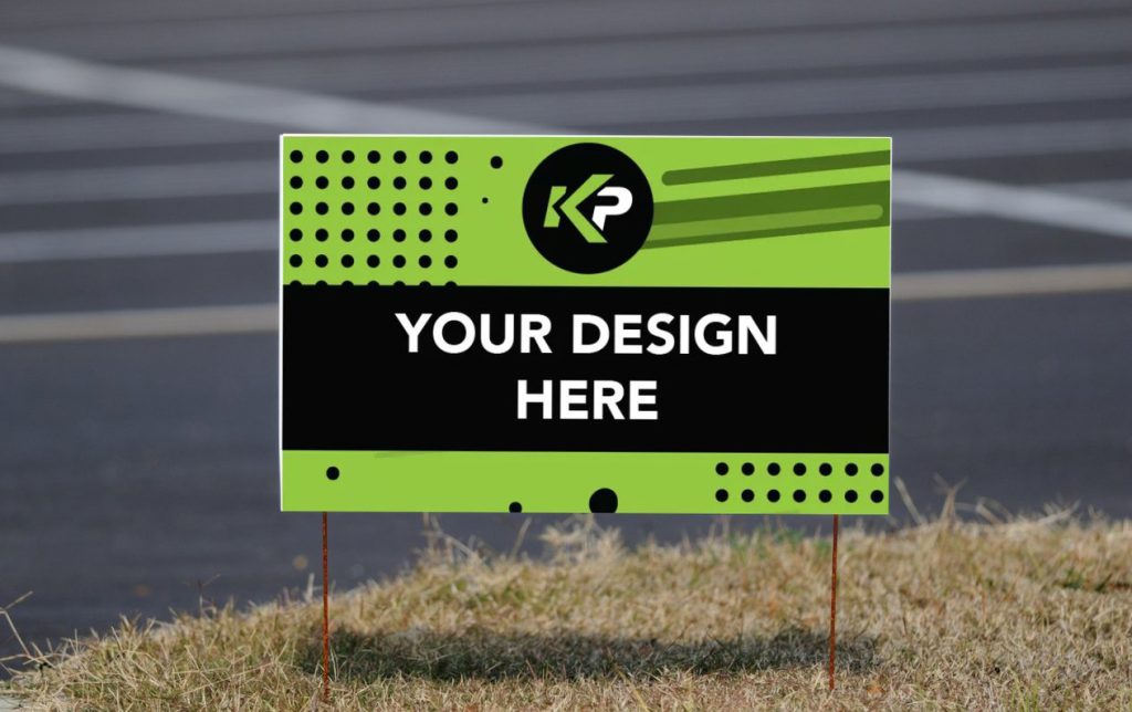 A green and black yard sign with modern graphic elements and the text YOUR DESIGN HERE in white, placed on grass beside a paved surface—perfect for yard signs to promote your business and drive sales.