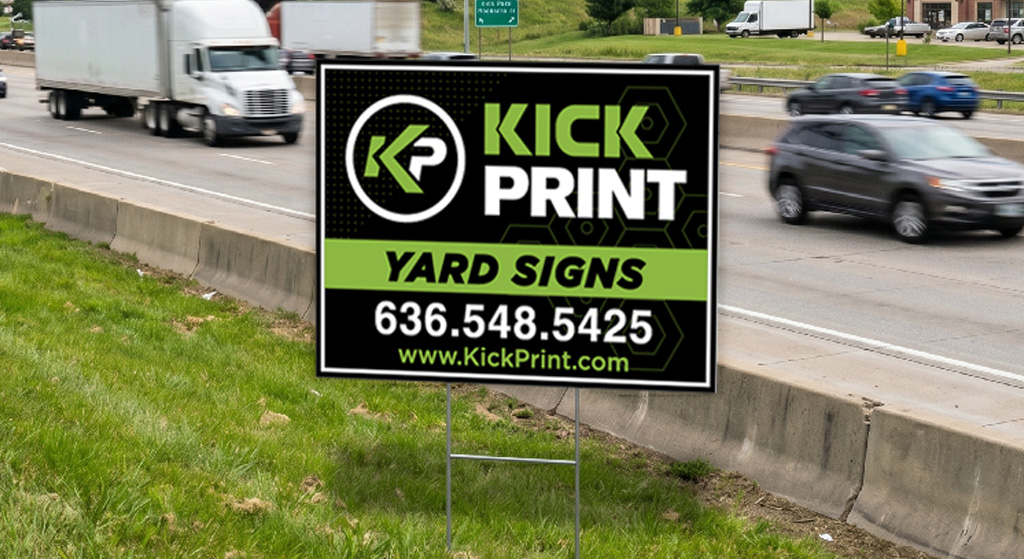 A yard sign by a busy highway advertises Kick Print Yard Signs to promote your business, with a phone number 636.548.5425 and website www.KickPrint.com. Cars and trucks drive by in the background, boosting visibility and sales.