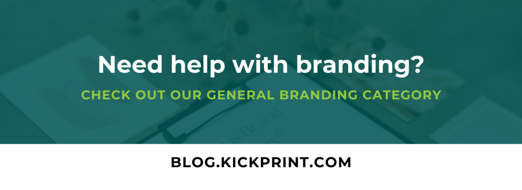 Promotional banner with the text: Need help with branding? Check out our general branding category. blog.kickprint.com over a blurred background with a clipboard.