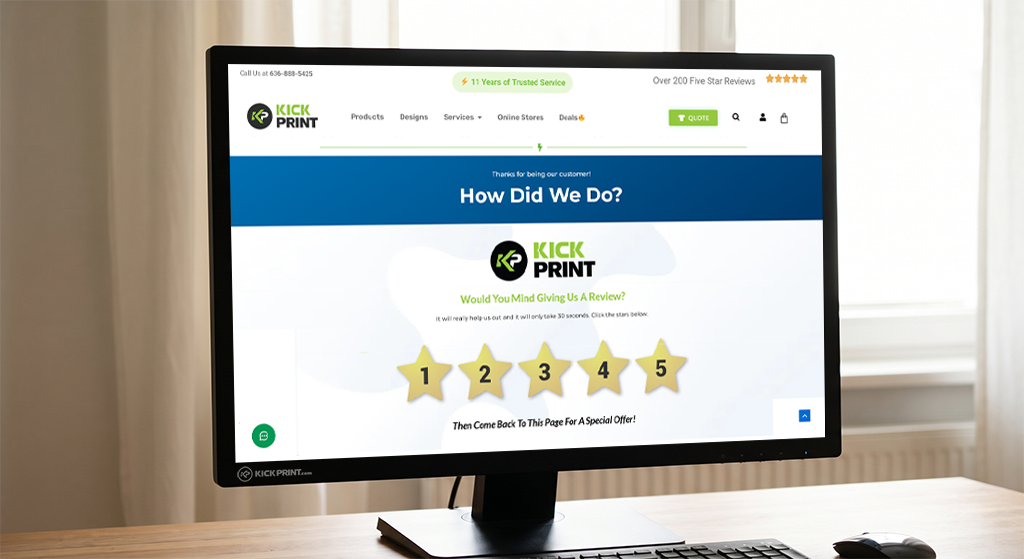 A computer monitor displays an online feedback page for Kick Print, asking How Did We Do? with a five-star rating system and a green logo at the top, motivating customers to share their customer feedback, on a desk near a window.