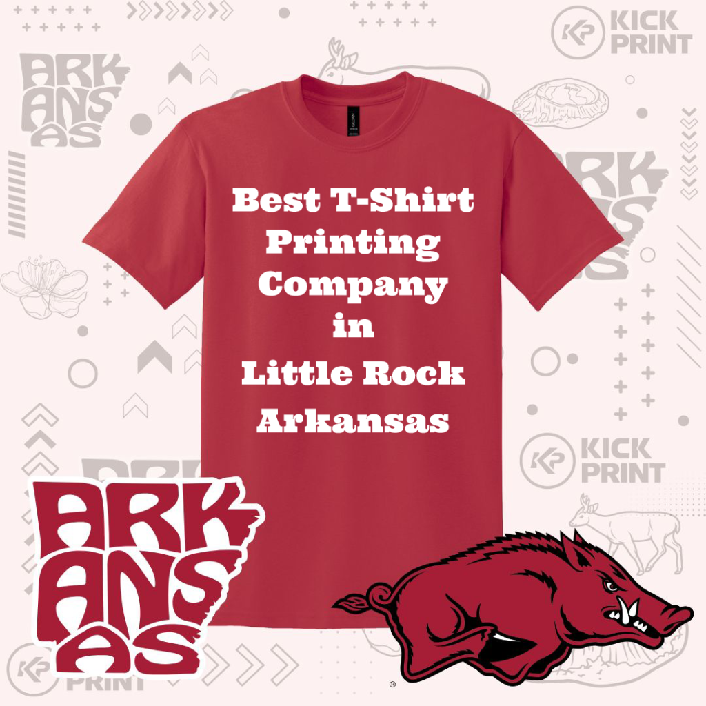 A red t-shirt displays the text Best T-Shirt Printing Company in Little Rock Arkansas in white bold letters. Surrounding graphics include ARKANSAS text, a razorback hog mascot, and the Kick Print logo.