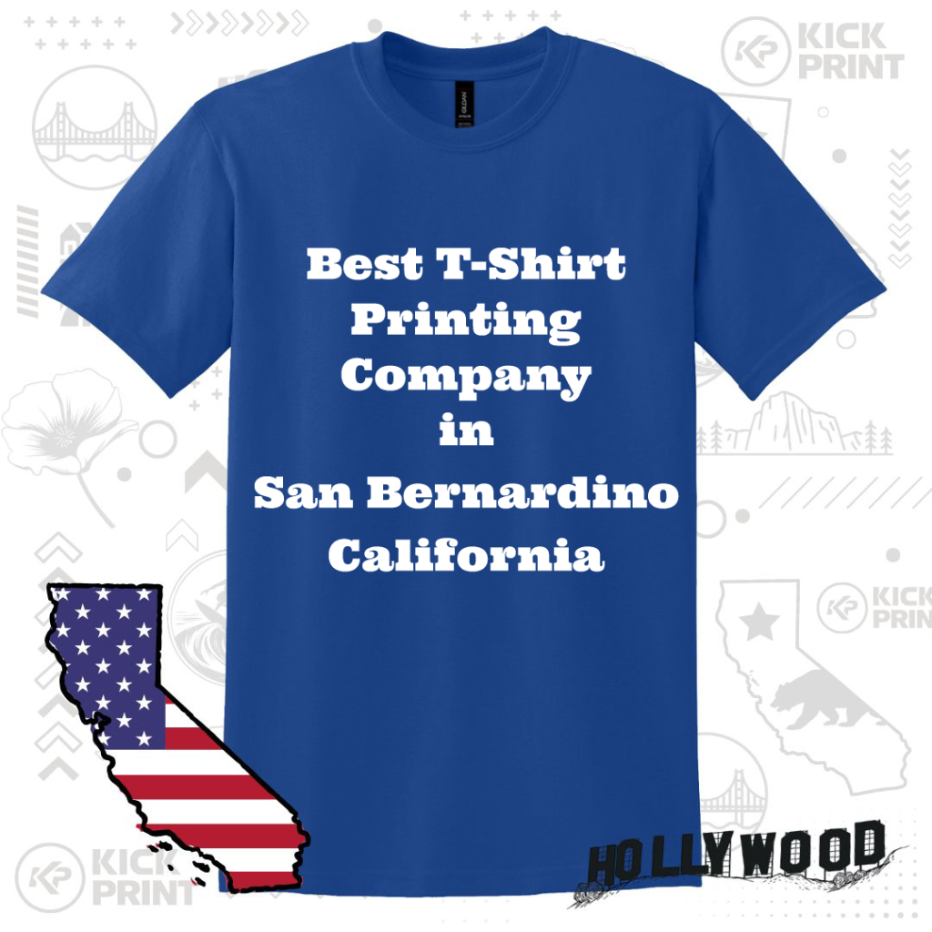 A blue T-shirt with bold white text that reads Best T-Shirt Printing Company in San Bernardino California. The background features California-themed graphics and a U.S. map with an American flag design.