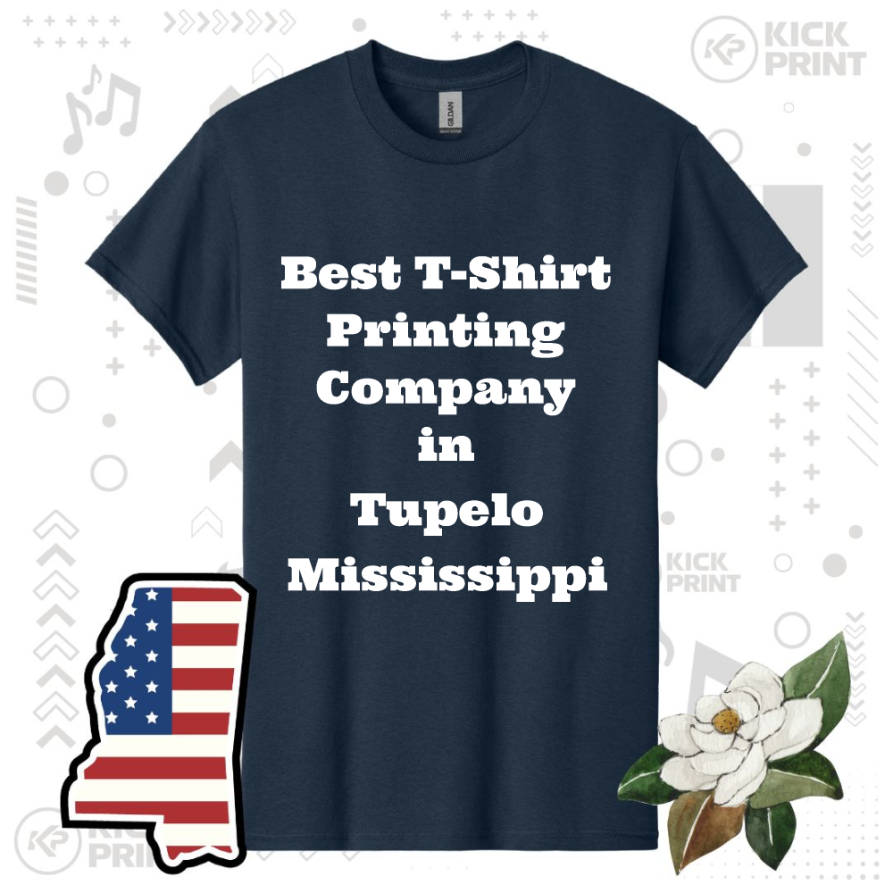 A navy blue T-shirt with bold white text reading, Best T-Shirt Printing Company in Tupelo Mississippi. The background features icons, an American flag in the shape of Mississippi, and a magnolia flower.