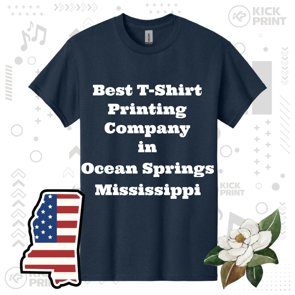 A navy blue t-shirt features the bold white text: Best T-Shirt Printing Company in Ocean Springs Mississippi. Surrounding the shirt are graphics of the state of Mississippi with a flag, a magnolia flower, and abstract shapes.