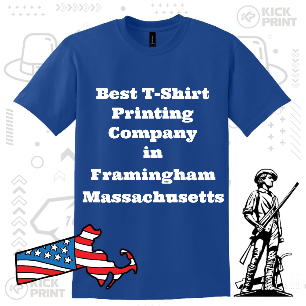 A blue t-shirt with bold white text reading: Best T-Shirt Printing Company in Framingham Massachusetts. The design includes an outline of Massachusetts with an American flag pattern and a black Minuteman illustration.