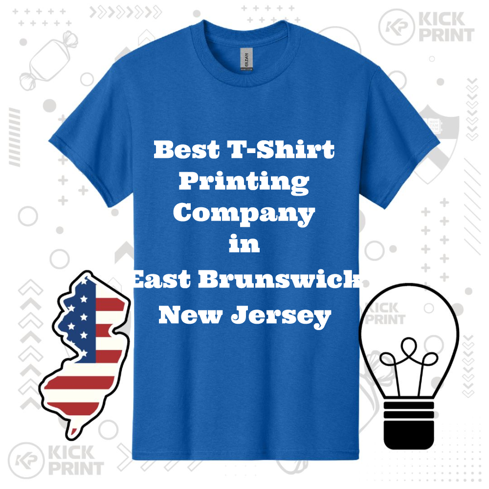 Blue t-shirt with bold white text reading Best T-Shirt Printing Company in East Brunswick New Jersey, surrounded by graphics of a New Jersey map with an American flag design and a black lightbulb icon.