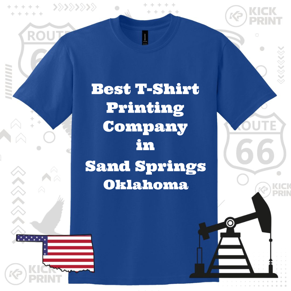 A blue T-shirt displays the text Best T-Shirt Printing Company in Sand Springs Oklahoma in bold white letters. The background features Route 66 signs, an oil pump, and an Oklahoma map with a U.S. flag design.