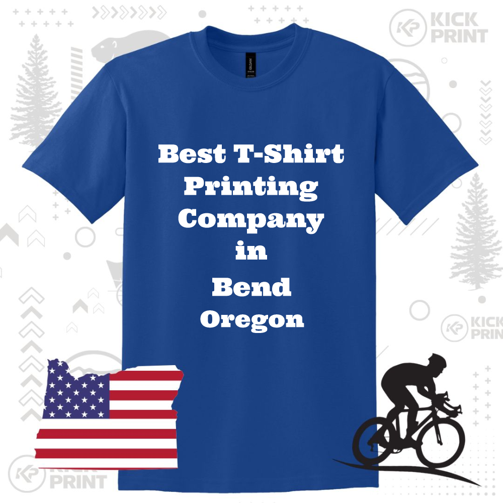 A blue T-shirt with the text “Best T-Shirt Printing Company in Bend Oregon” in bold white letters. The background includes an American flag, a cyclist silhouette, and subtle graphic elements.