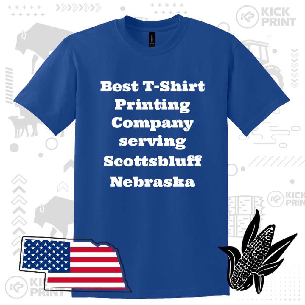 A blue T-shirt displays the text Best T-Shirt Printing Company serving Scottsbluff Nebraska in bold white letters. The background has farm-themed graphics, a U.S. flag in Nebraskas shape, and a black corn illustration.
