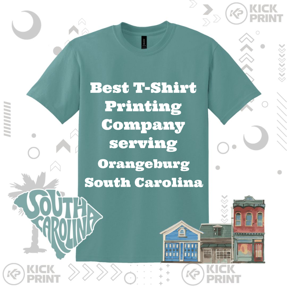 A teal T-shirt with bold white text that reads Best T-Shirt Printing Company serving Orangeburg South Carolina. The background includes illustrated buildings, a South Carolina graphic, and the Kick Print logo.